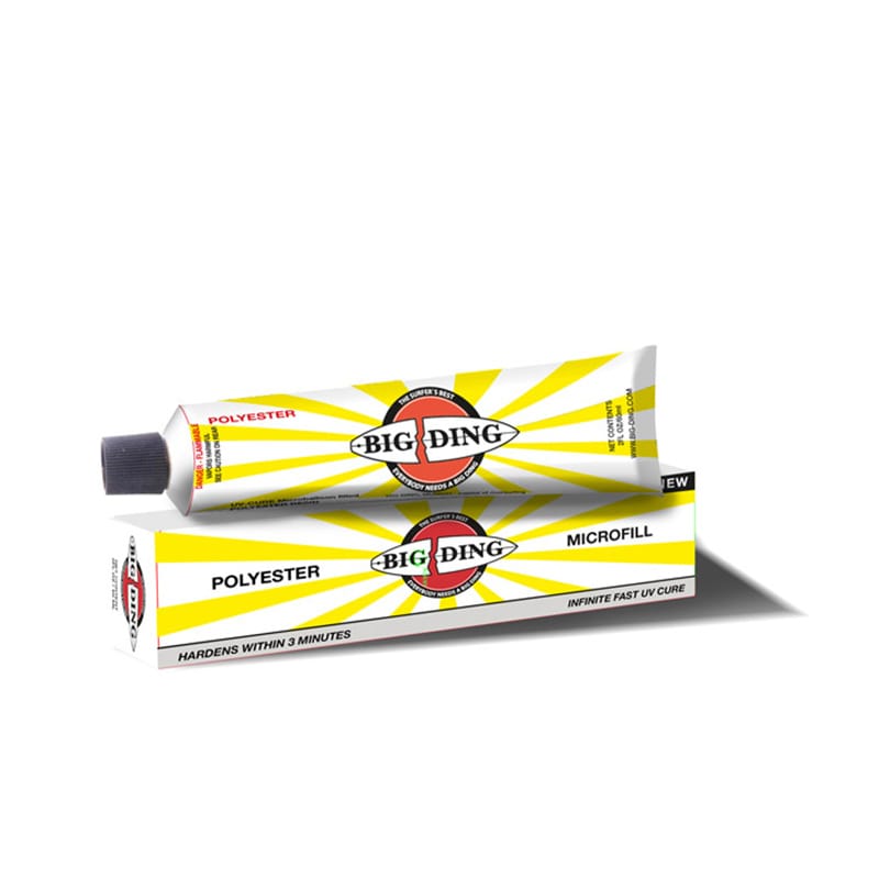 Eine Tube Big Ding UV Cure Polyester Microfill mit einer schwarzen Kappe sitzt auf der Schachtel, beide mit einem gelben Sonnenschliff und einem auffälligen schwarz-roten Big Ding Branding für eine einfache Surfboard-Reparatur.