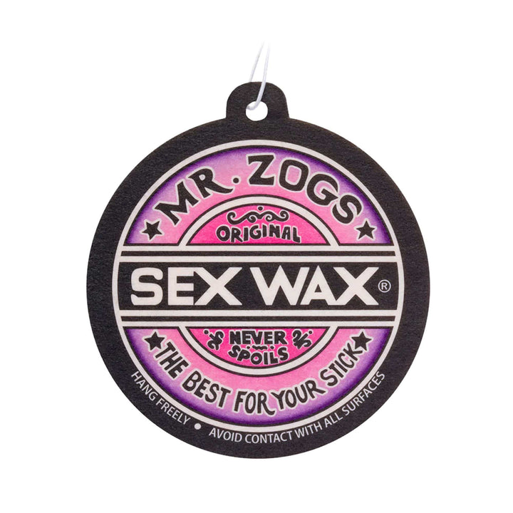 Der SEX WAX Lufterfrischer von SEX WAX ist ein runder Lufterfrischer mit einem Loch an der Spitze, auf dem "Mr. Zogs Original Sex Wax Never Spoils The Best For Your Stick" auf einem rosa und schwarzen Hintergrund steht.