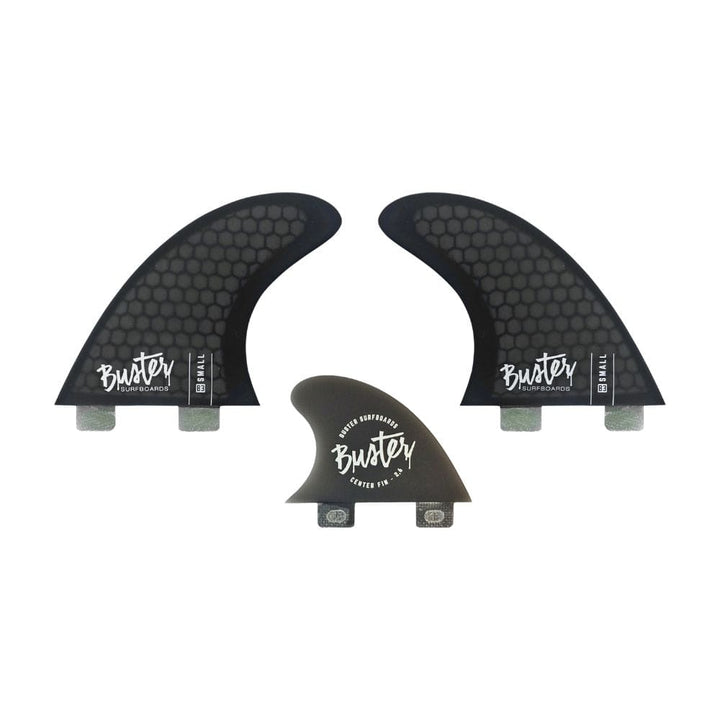 Drei schwarze Buster-Surfboards Honeycomb FCS I Rapid Set Finnen - zwei große und eine kleine - mit Wabenmuster und weißem Buster-Logo, ideal für Riversurfer, die ein leistungsstarkes Finnenset suchen.